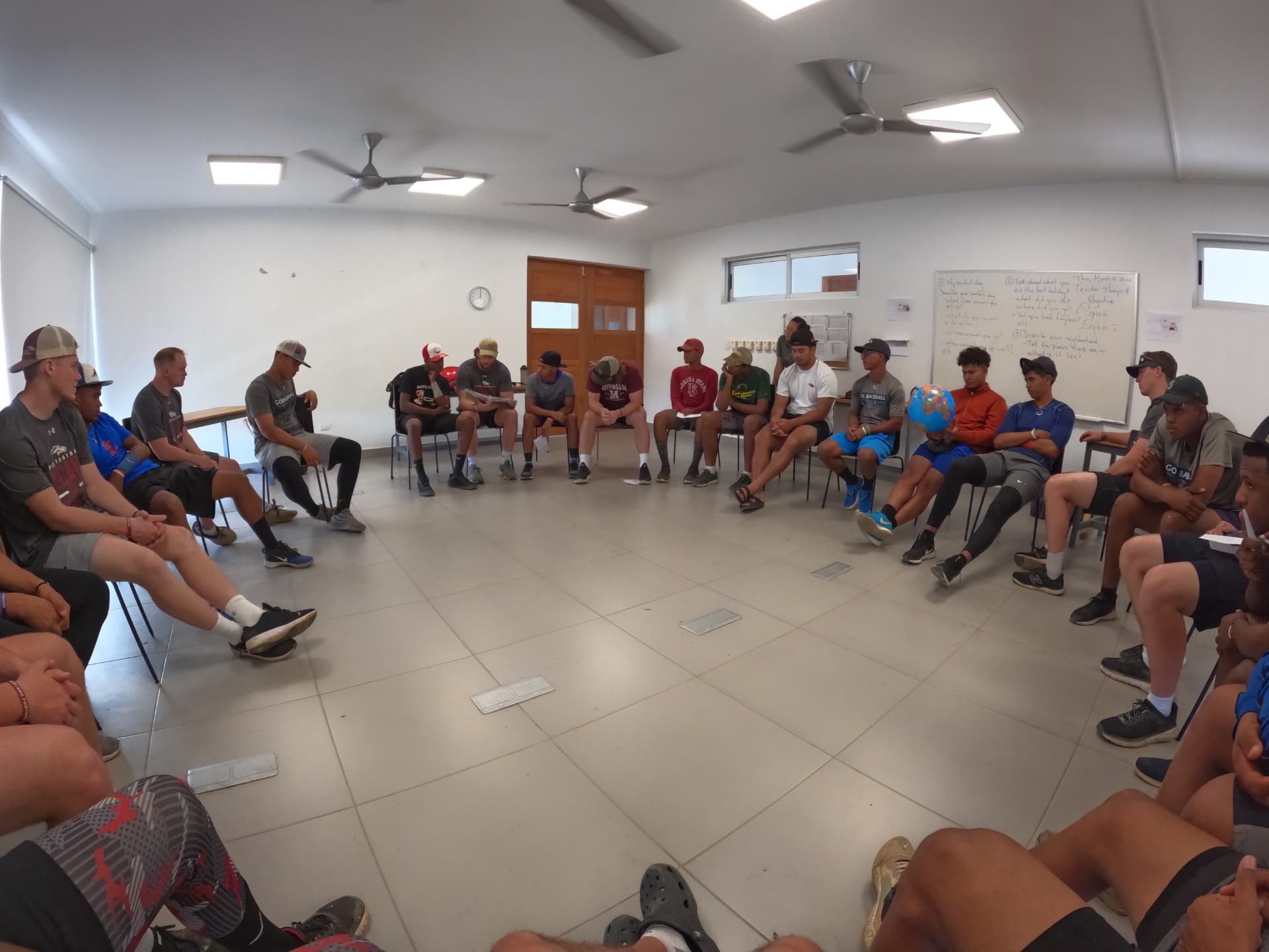 The whole team seated in a wide circle for a morning devotional